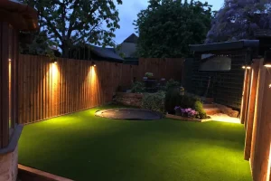 Downlighters enhancing your beautiful artificial lawn by Luxury Lawns.
