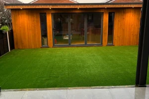 Outdoor office space with a luxury grass lawn in front of it.