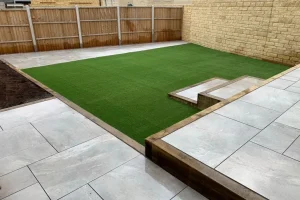 Great sitting out area overlooking a green artificial grass lawn.
